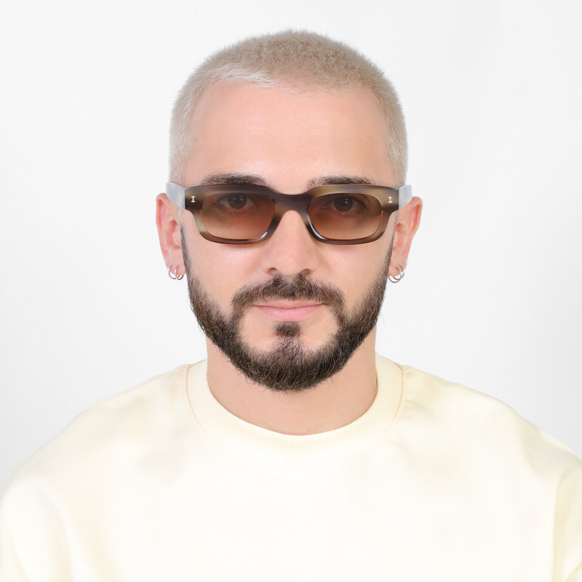 Man wearing Cali E Sunglasses in Java with Taupe Gradient lenses, Model with a platinum buzzcut