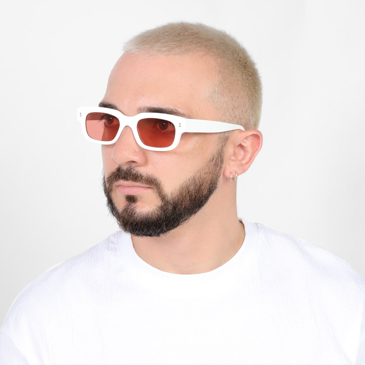 Man wearing Cali E Sunglasses in White with Guava See Through lenses, Bearded model looking right