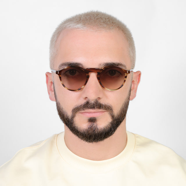 Model with platinum buzzcut wearing Capri Sunglasses Sand Dune with Brown Gradient