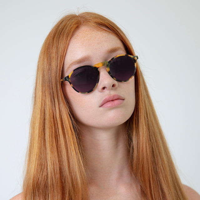 Model with straight, red hair wearing Capri Sunglasses Tortoise with Grey