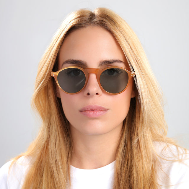 Blond woman in white tee wearing Capri Sunglasses Honey with Olive