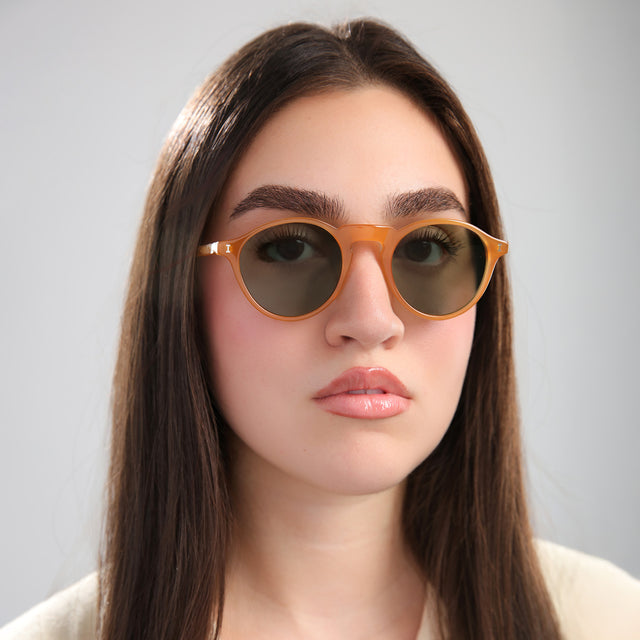 Brunette model wearing Capri Sunglasses Honey with Olive