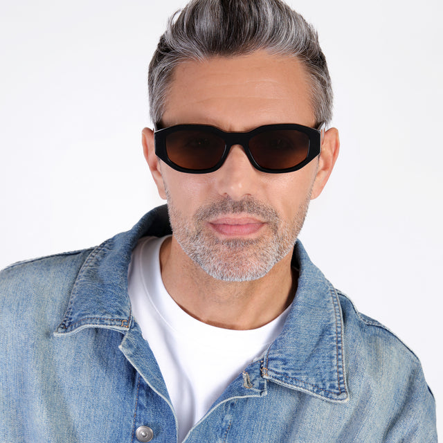 Model with salt and pepper hair and beard wearing Cassette Sunglasses Black with Brown Flat