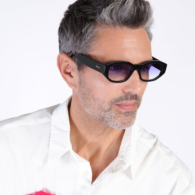 Model with salt and pepper hair and beard looking left wearing Cassette Sunglasses Black with Purple Flat Gradient