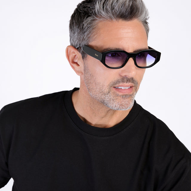 Model with salt and pepper hair and beard looking left wearing Cassette Sunglasses Black with Purple Flat Gradient