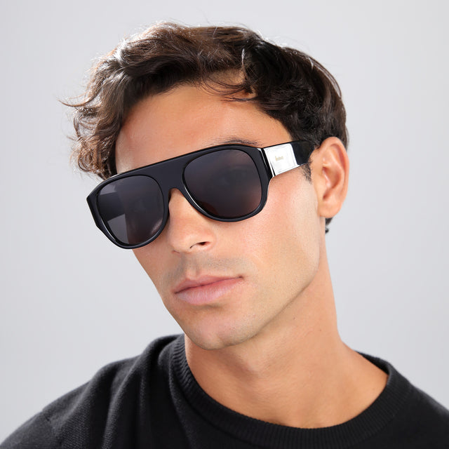Man with brown hair in a black tee wearing Colorado Sunglasses Black with Grey