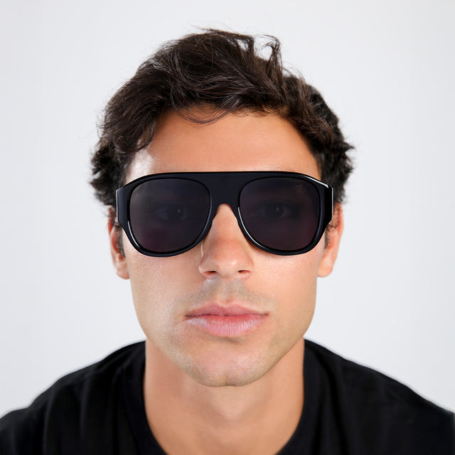 Another angle of man with brown hair in a black tee wearing Colorado Sunglasses Black with Grey
