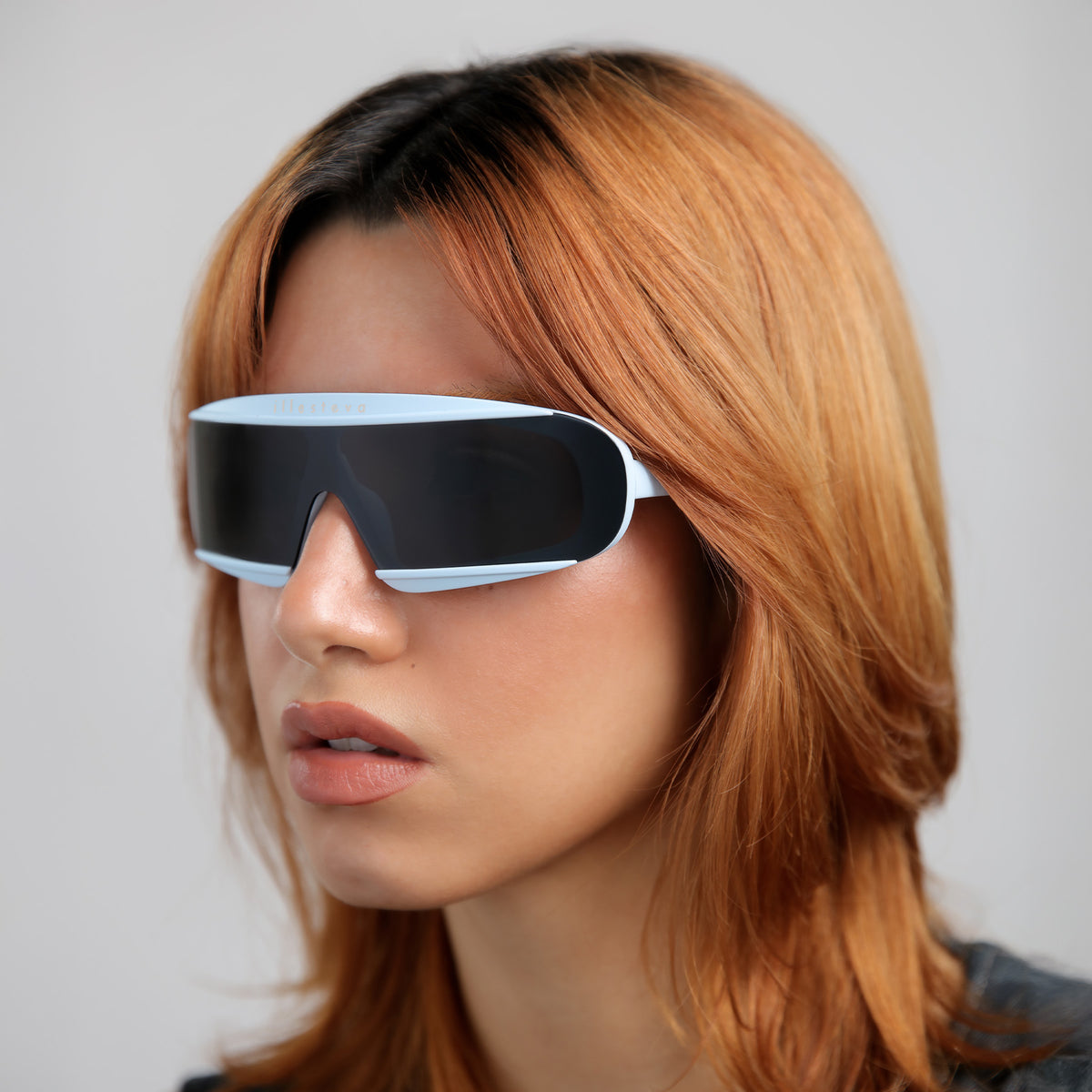 Woman wearing Courchevel Sunglasses in Matte Baby Blue with Grey lenses, Red-haired model