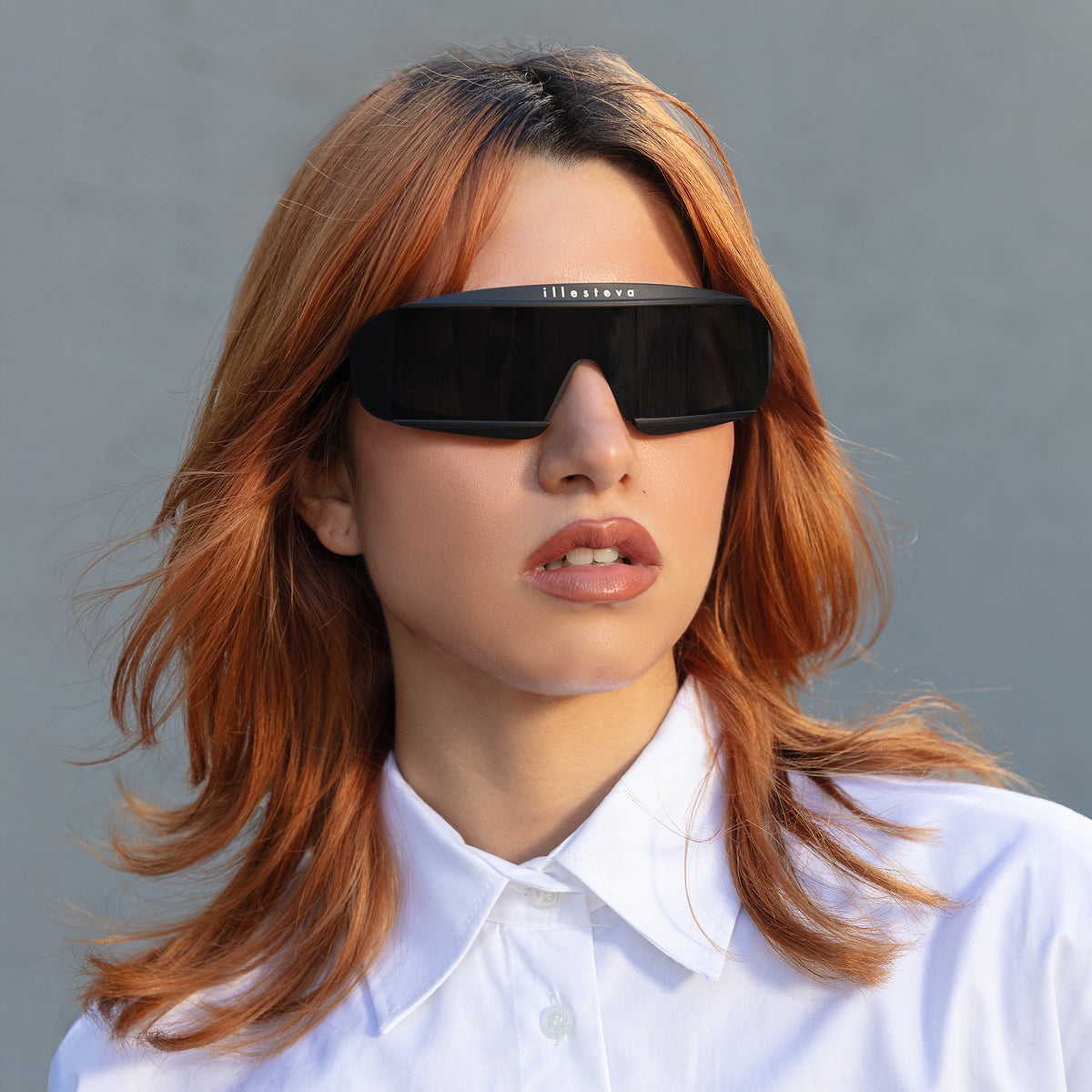 Woman wearing Courchevel Sunglasses in Matte Black with Grey lenses, Another angle of red-haired model