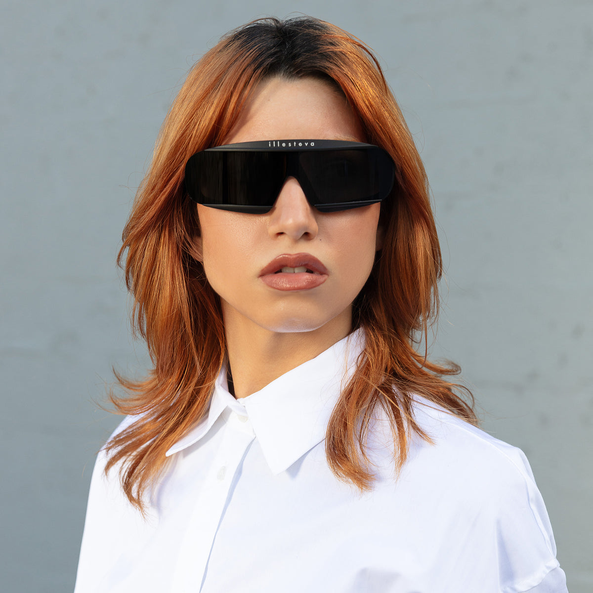 Woman wearing Courchevel Sunglasses in Matte Black with Grey lenses, Red-haired model