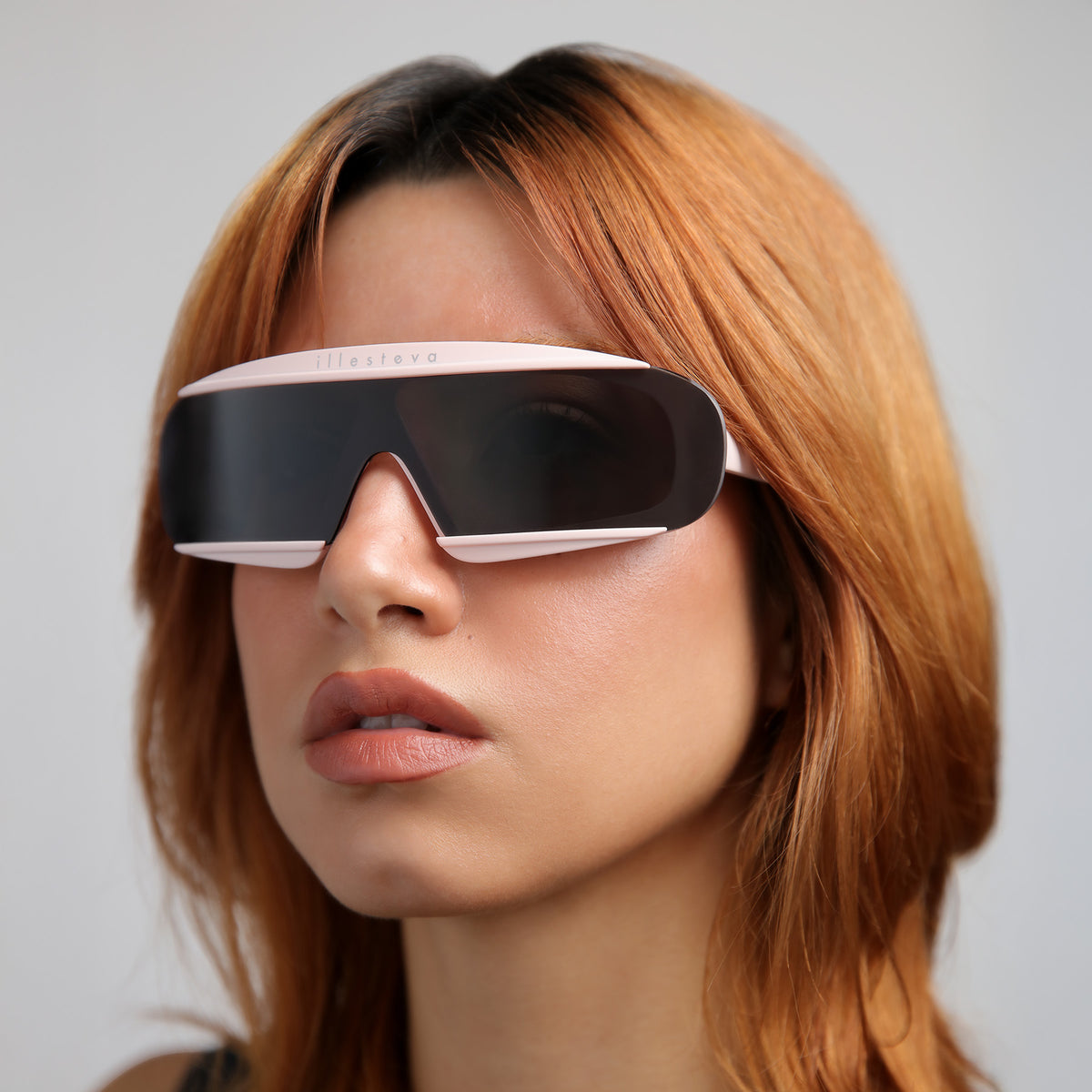 Woman wearing Courchevel Sunglasses in Matte Blush with Grey lenses, Red-haired model