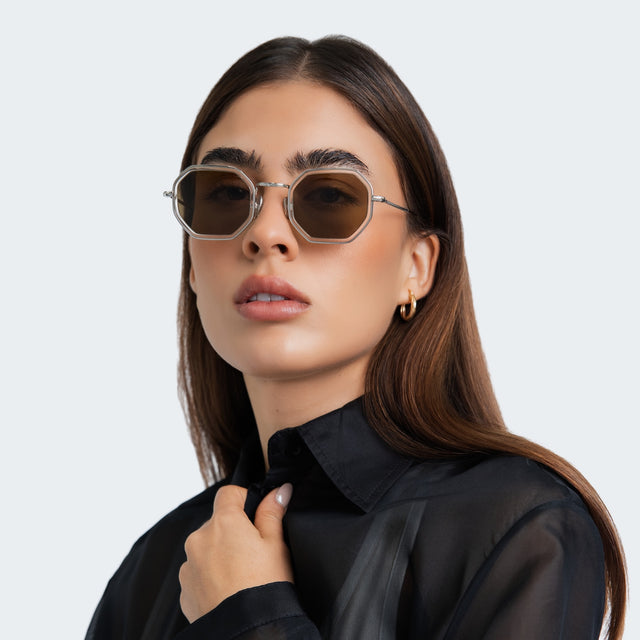 Another angle of the woman wearing Dylan Tate Sunglasses Champagne Silver with Brown Flat