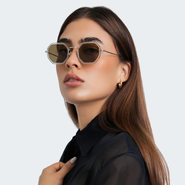 Woman in a black satin blouse wearing Dylan Tate Sunglasses Champagne Silver with Brown Flat