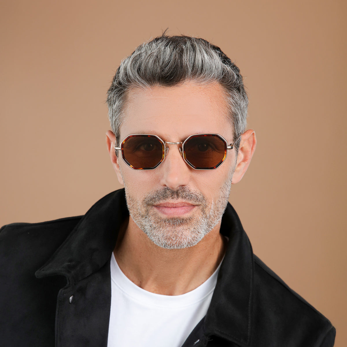 Man wearing Dylan Tate Sunglasses in Star Tortoise with Gold lenses, front view, Model with salt and pepper hair and beard in a black leather jacket