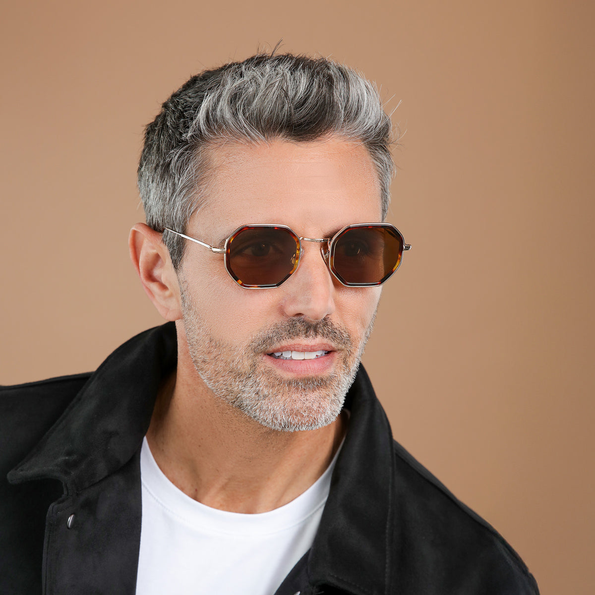 Man wearing Dylan Tate Sunglasses in Star Tortoise with Gold lenses, side profile, Model with salt and pepper hair and beard in a black leather jacket looking left