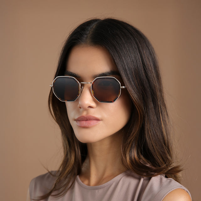 Brunette model in a clay mockneck blouse wearing Dylan Tate Sunglasses Star Tortoise/Gold with Brown Flat