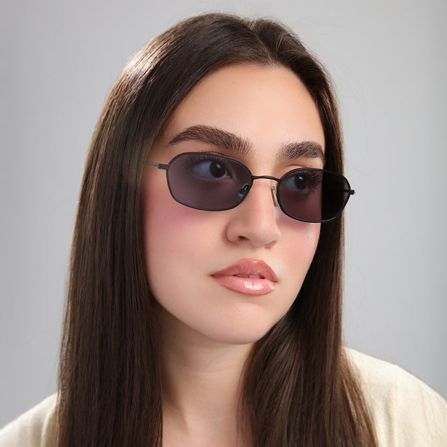 Another angle of brunette model in a cream blouse wearing East Houston Sunglasses Matte Black with Grey Flat