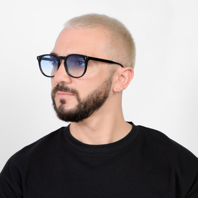 Bearded model looking right wearing Eldridge 56 Sunglasses Black with Blue Flat Gradient See Through