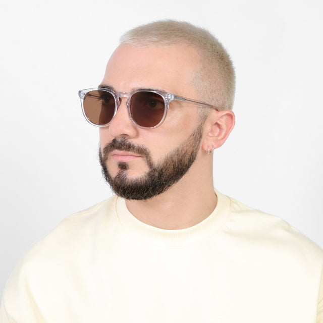 Bearded model looking right wearing Eldridge 56 Sunglasses Clear with Brown Flat