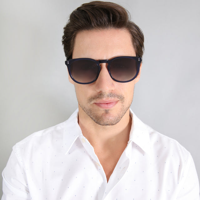 Model with brown hair combed sideways wearing Eldridge 56 Sunglasses Navy with Grey Flat Gradient