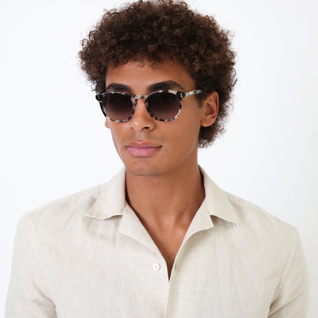 Model with natural afro-curly wearing Eldridge Sunglasses White Tortoise with Grey Flat Gradient