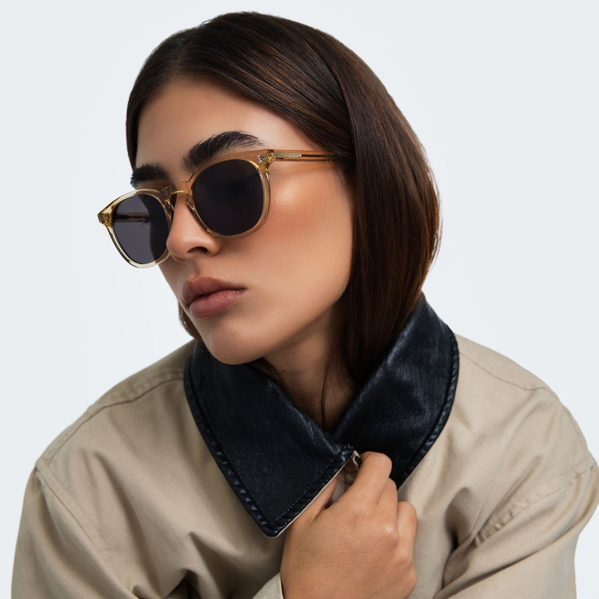 Woman wearing Eldridge 56 Sunglasses in Citrine with Grey Flat lenses, front view, Woman in a trench coat