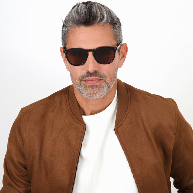 Model with salt and pepper hair and beard wearing Eldridge Sunglasses Black with Brown Flat