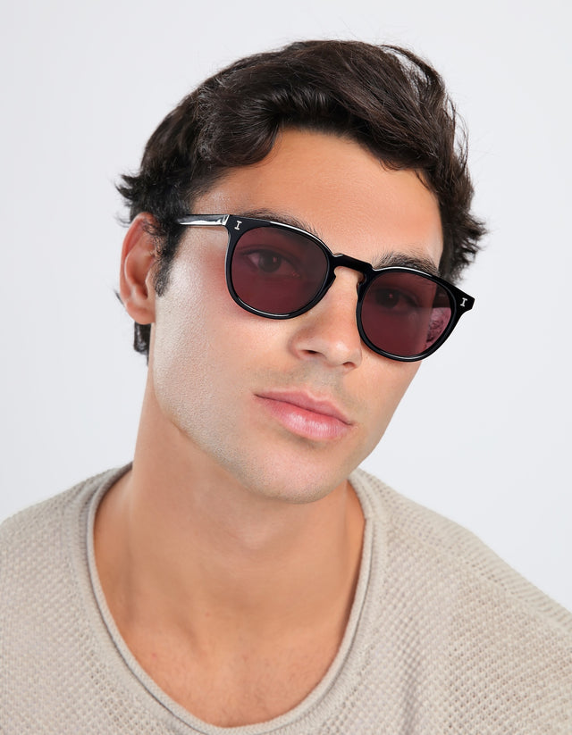 Man wearing Eldridge Sunglasses in Black with Plum Flat See Through lenses
