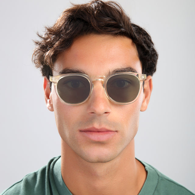Man with brown hair in a green shirt wearing Eldridge Sunglasses Champagne with Olive Flat