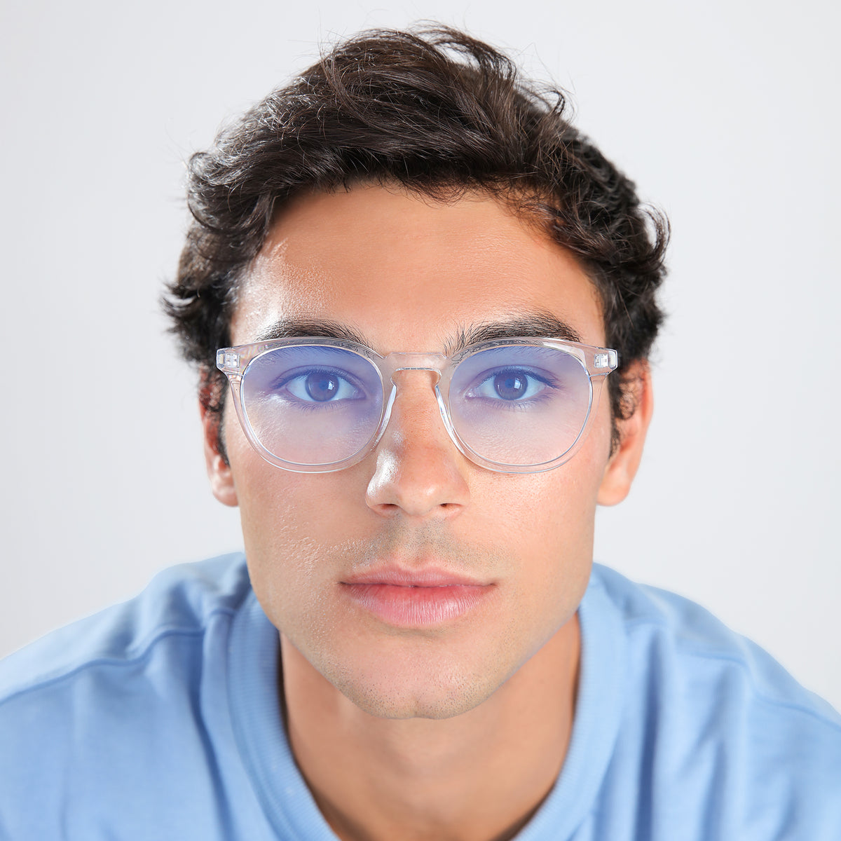 Man wearing Eldridge Sunglasses in Clear with Blue Flat Gradient See Through lenses, front view, Another angle of man with brown hair in a blue shirt