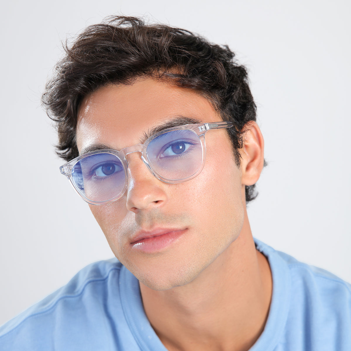 Man wearing Eldridge Sunglasses in Clear with Blue Flat Gradient See Through lenses, front view, Man with brown hair in a blue shirt