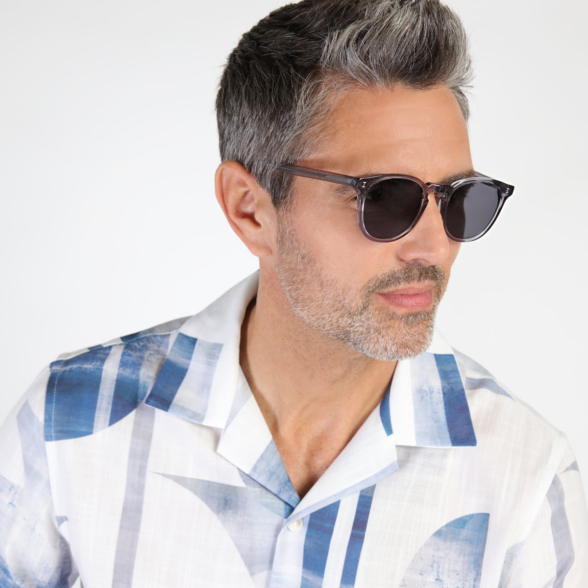 Man wearing Eldridge Sunglasses in Mercury with Grey Flat lenses, Model with salt and pepper hair and beard looking left