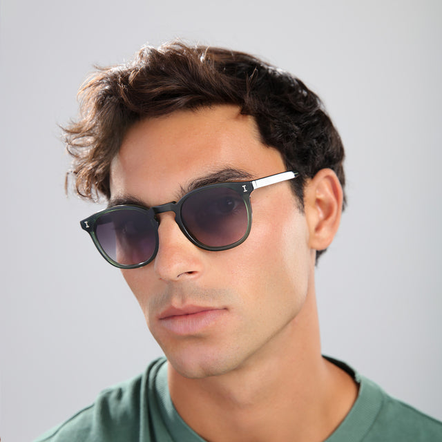 Man in a green tee wearing Eldridge Sunglasses Pine with Grey Flat Gradient