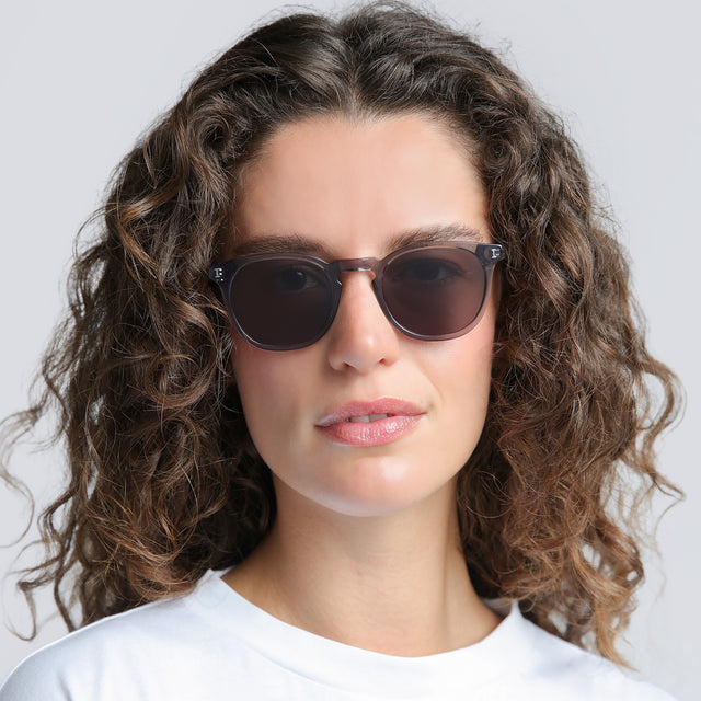 Woman in a white tee shirt wearing Eldridge Light Polarized Sunglasses Mercury with Grey Polarized