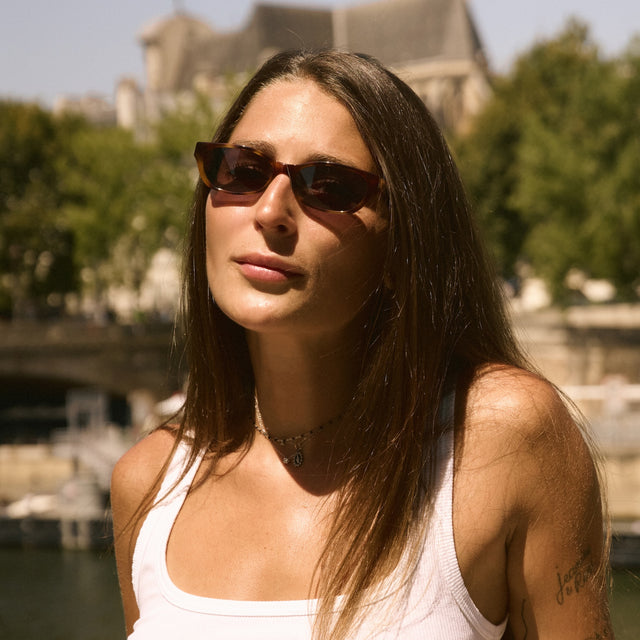 Woman in Paris near trees wearing Encinitas Sunglasses Havana with Grey