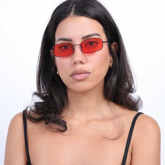 Brunette model wearing Flushing Sunglasses Black with Red Flat See Through