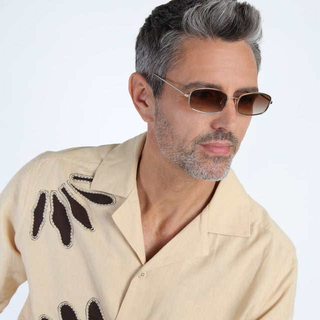 Model with salt and pepper beard looking left wearing Flushing Sunglasses Rose Gold with Brown Flat Gradient