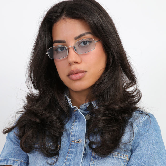 Brunette model wearing Flushing Sunglasses Silver with Light Blue Flat See Through