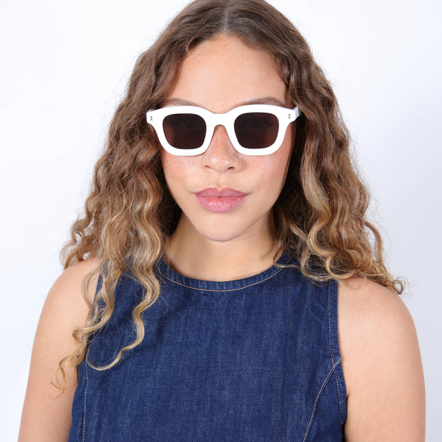 Brunette model with ombre curls wearing George Sunglasses White with Brown Flat