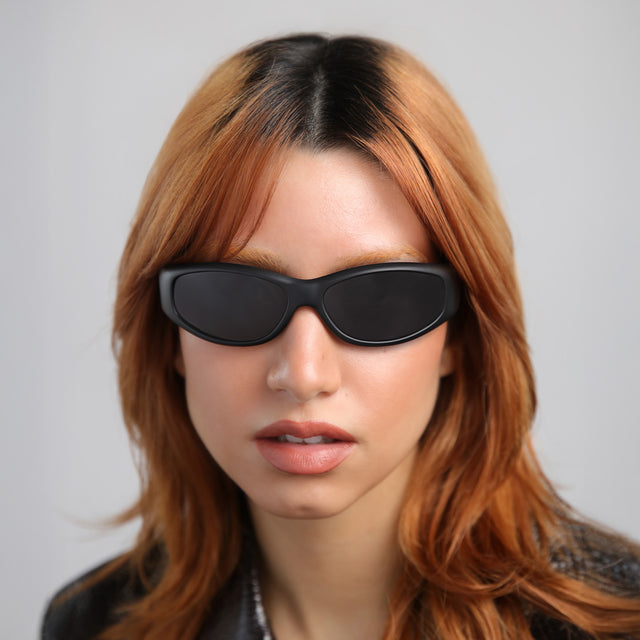 Another angle of woman with red hair wearing Granada 60 Sunglasses Matte Black