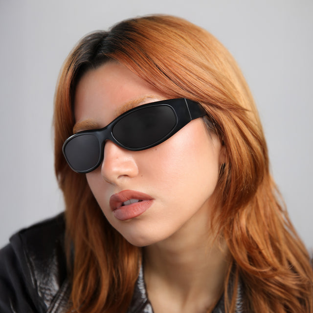 Woman with red hair wearing Granada 60 Sunglasses Matte Black