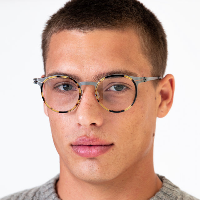 Model with buzzcut hairstyle wearing Great Jones Titanium Optical Tortoise/Matte Silver Optical