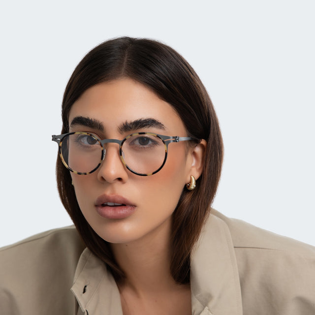 Woman in a blazer wearing Great Jones Titanium Optical Tortoise/Matte Silver  Optical