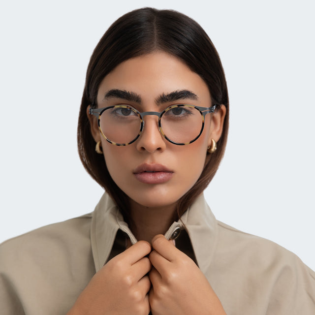 Another angle of woman in a blazer wearing Great Jones Titanium Optical Tortoise/Matte Silver  Optical