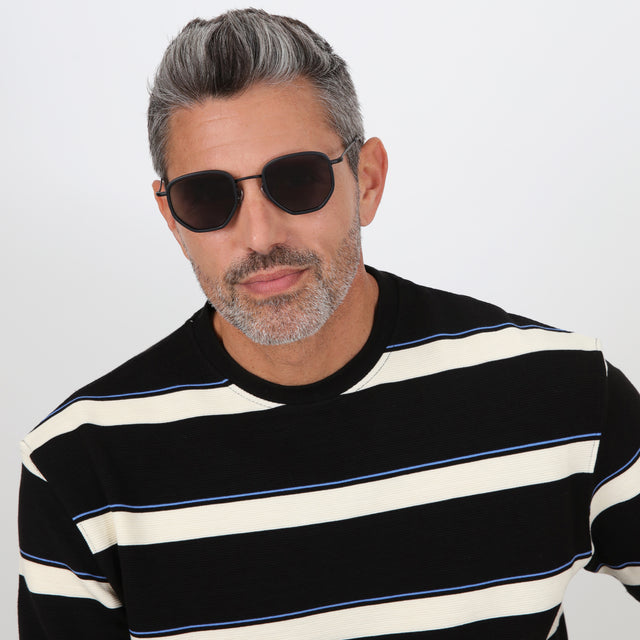 Model with salt and pepper hair and beard wearing Hunter Ace Sunglasses Matte Black with Grey