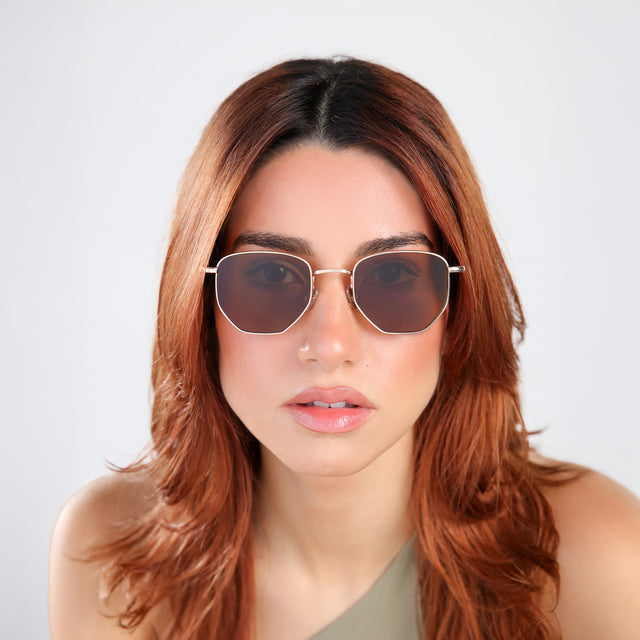 Woman with red hair in an olive blouse wearing Hunter Sunglasses Gold with Brown