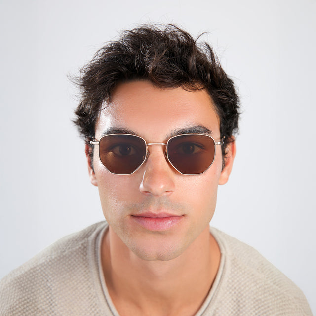 Another angle of man with brown hair in a beige waffled sweatshirt wearing Hunter Sunglasses Gold with Brown