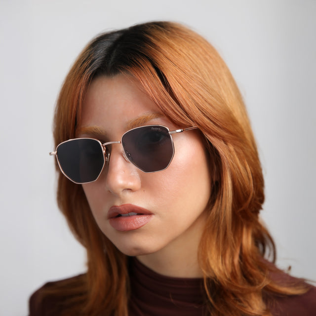 Model with red hair wearing Hunter Sunglasses Rose Gold with Grey