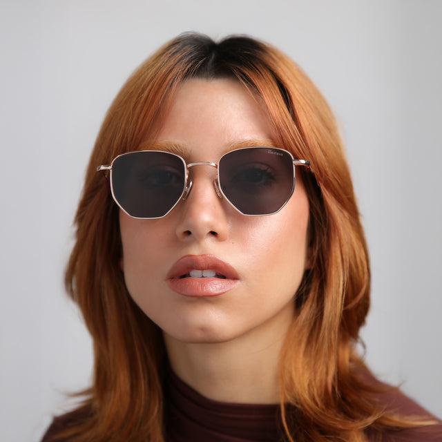 Another angle of model with red hair wearing Hunter Sunglasses Rose Gold with Grey