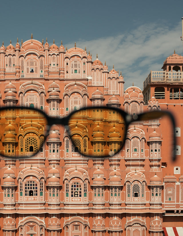 Beautiful building in India shown in the background with Bogota Sunglasses with Custom Honey lenses in the foreground